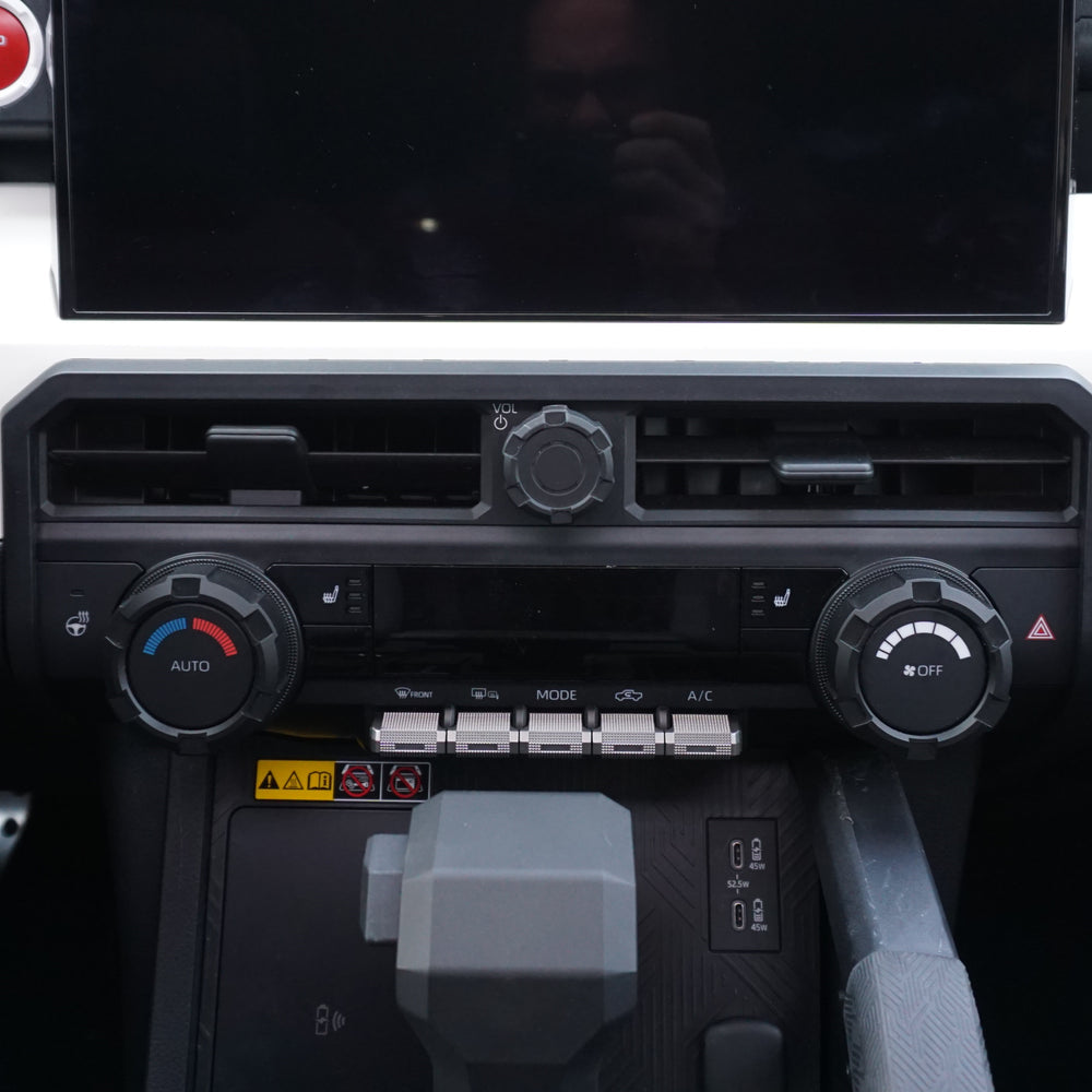 AJT Design center vent trim above the climate controls in a 2024+ Toyota Tacoma