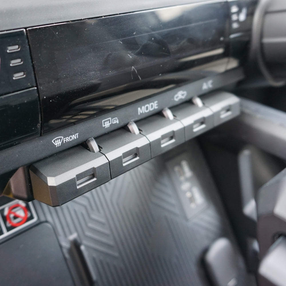 AJT Design toggle covers installed on a Toyota Tacoma, angled view