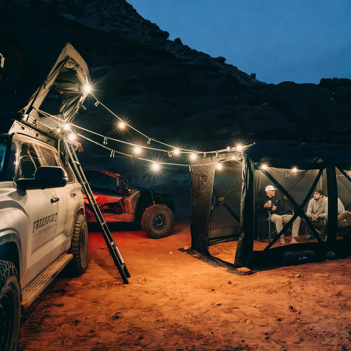 Freespirit Recreation camping string lights with speakers at camp with a Toyota