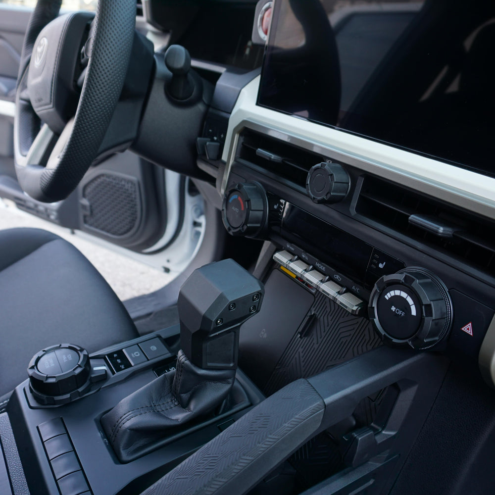 Driver view of AJT Design V2 knobs installed in a Toyota Tacoma