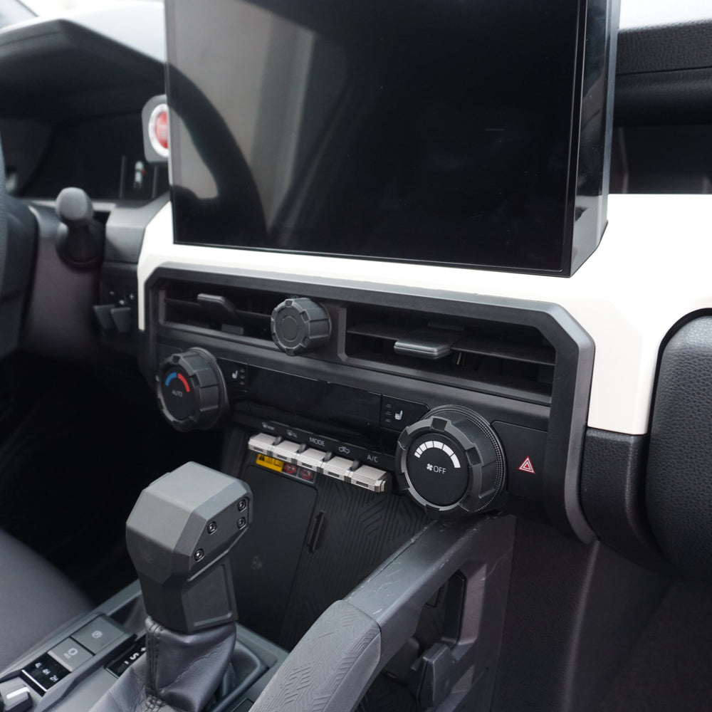 AJT Design center vent trim installed below the touchscreen in a 2024+ Toyota Tacoma