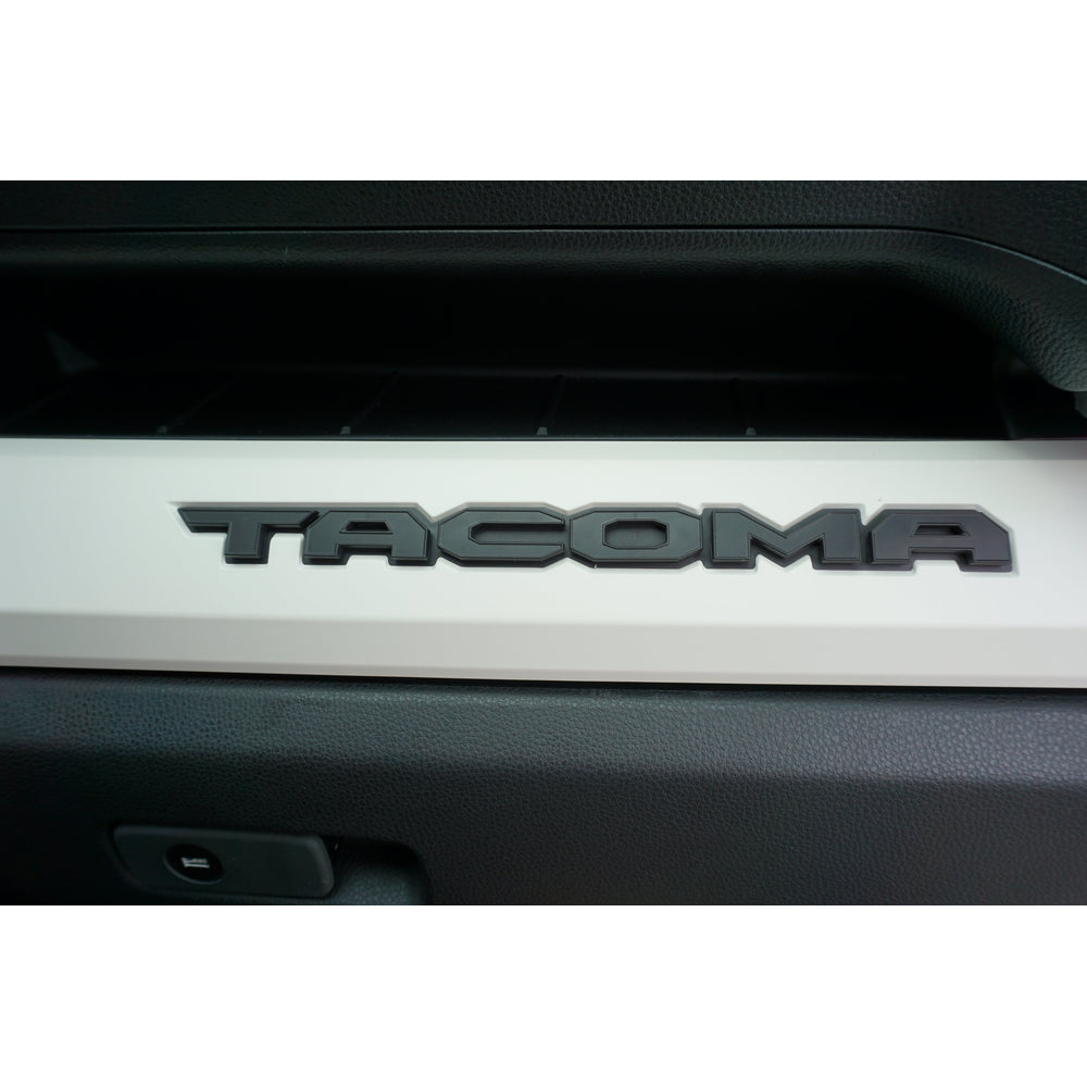 Glovebox letters on a Tacoma dash, straight on view