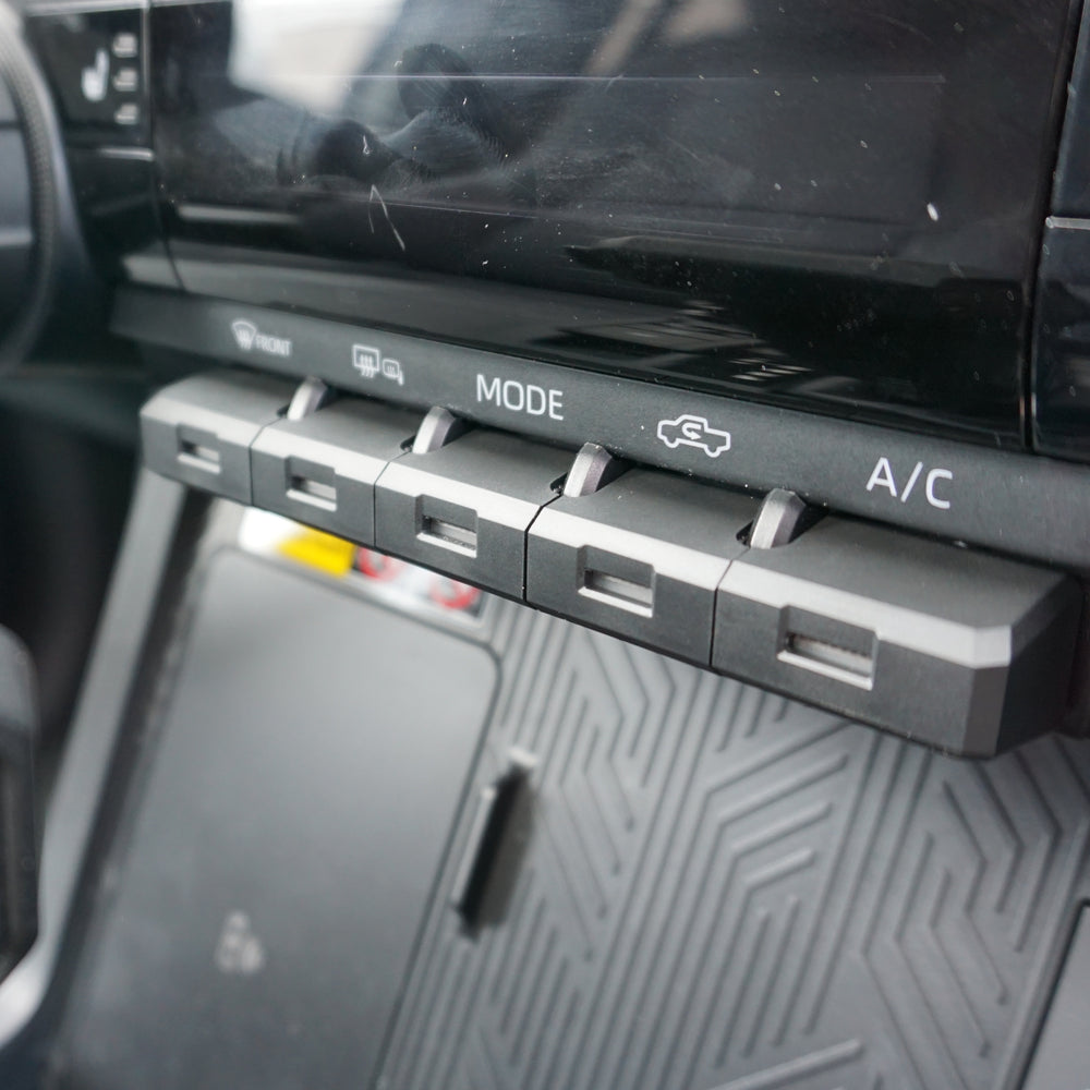 Close up of AJT Design toggle covers on a Toyota Tacoma dash