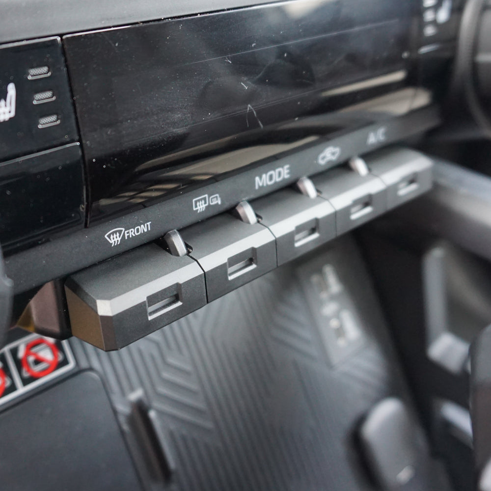 AJT Design toggle covers on Tacoma climate controls, side angle